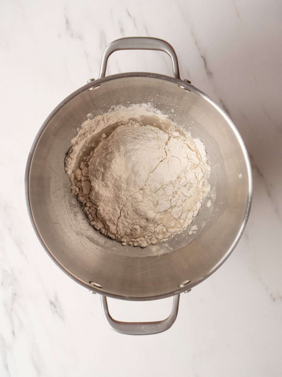 Bowl of flour on marble surface