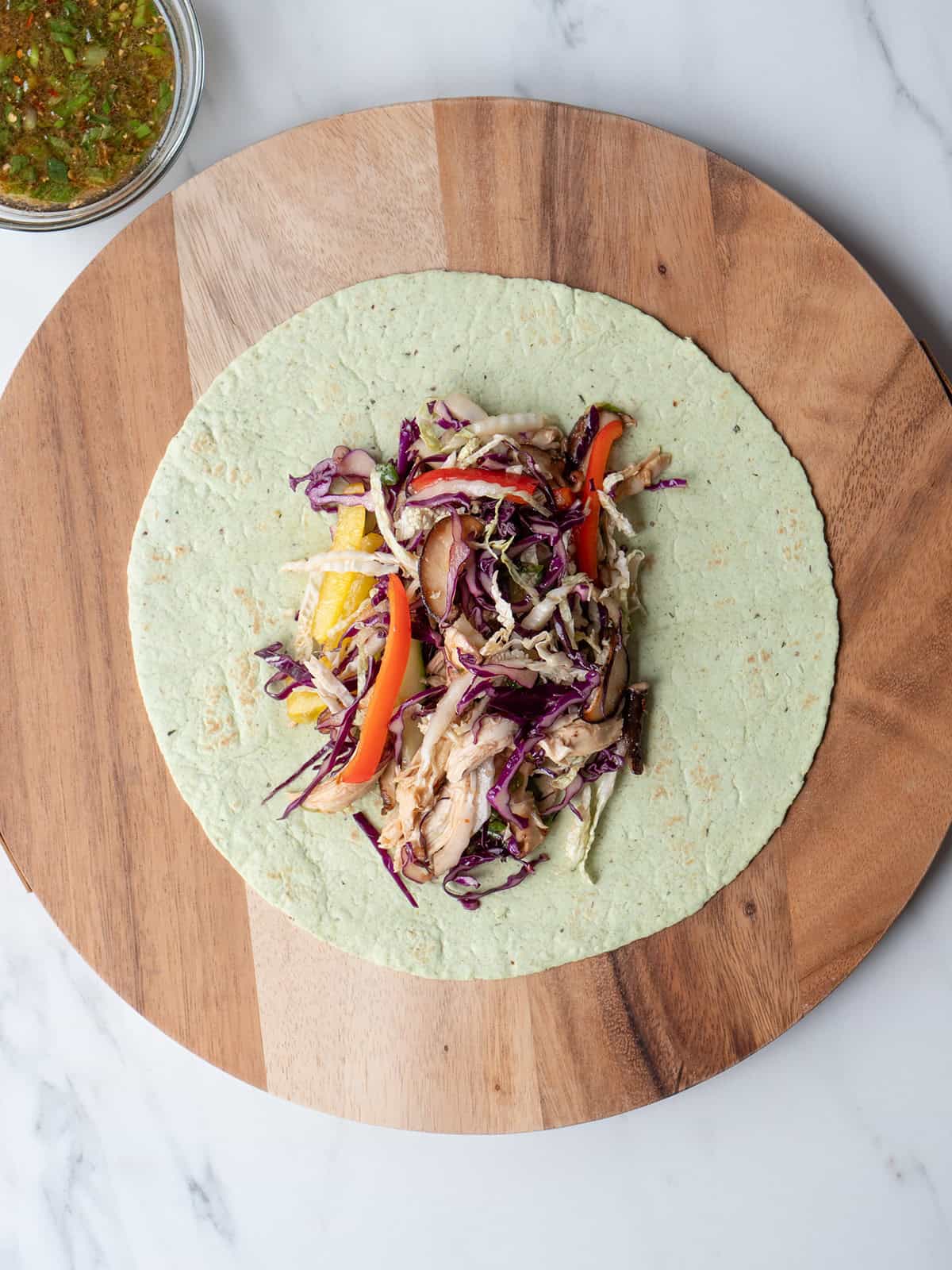 Colorful chicken and vegetable wrap ingredients