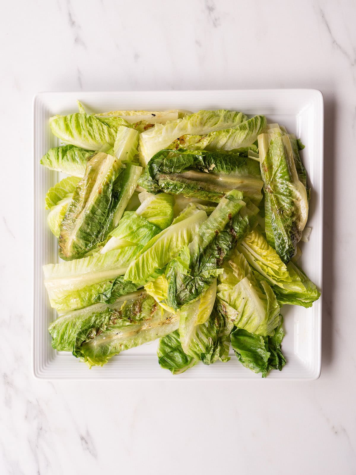 Grilled romaine lettuce on plate