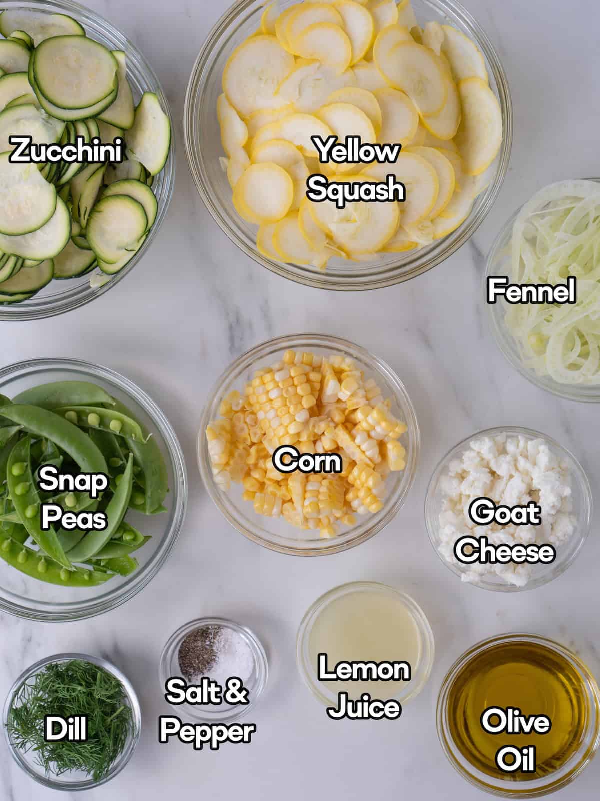 Mise en place of all ingredients to make a raw summer salad with squash and zucchini.