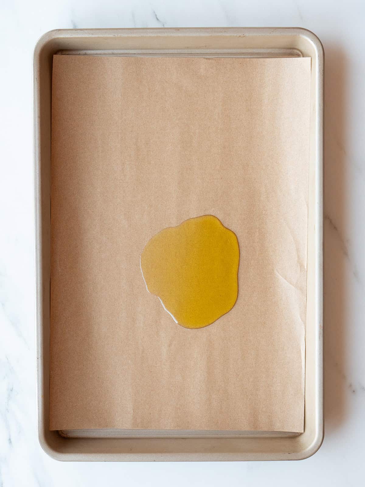 Baking sheet with oil on parchment