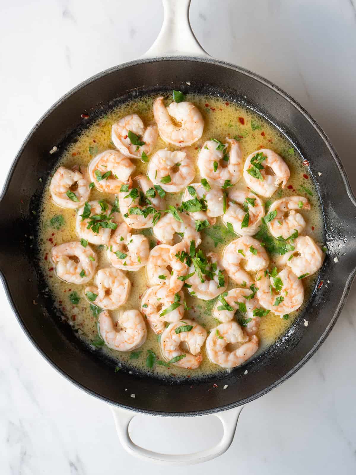 Cooked shrimp in a skillet.