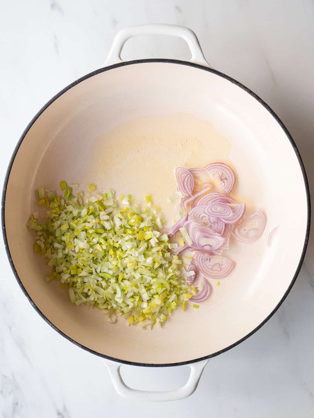Chopped shallots and leeks in pan
