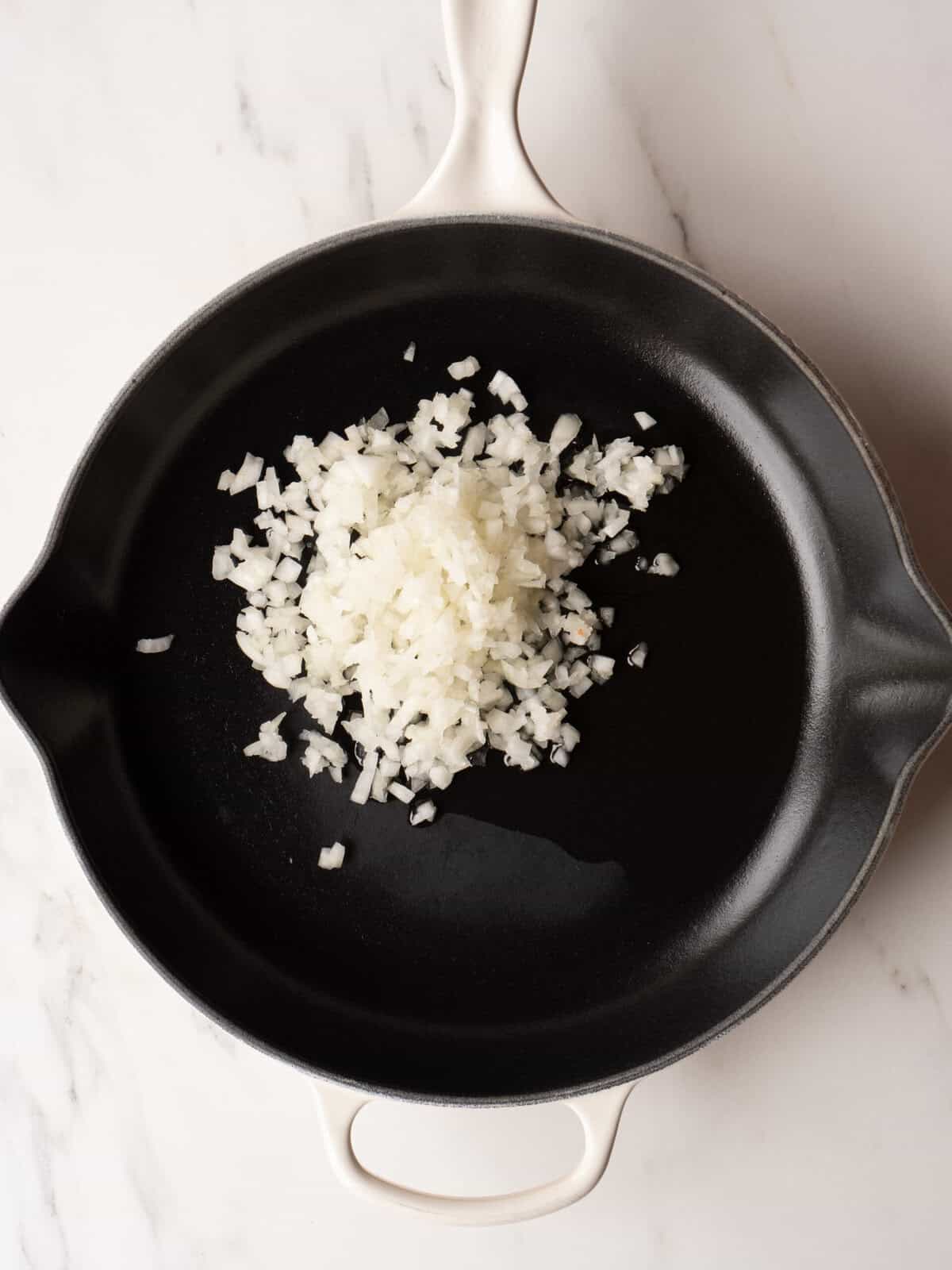 Chopped onions in a skillet.