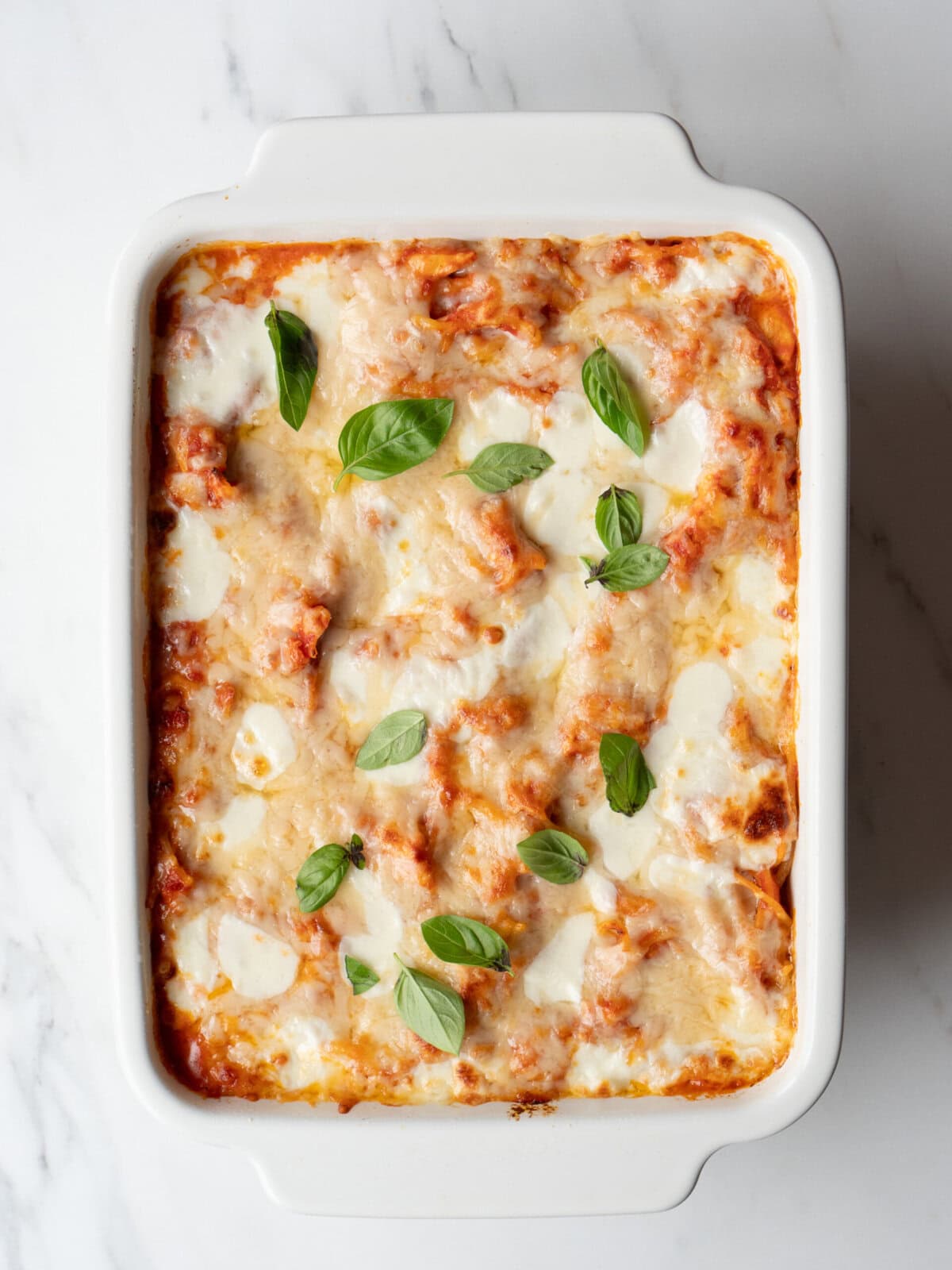 Baked pasta with cheese and basil.