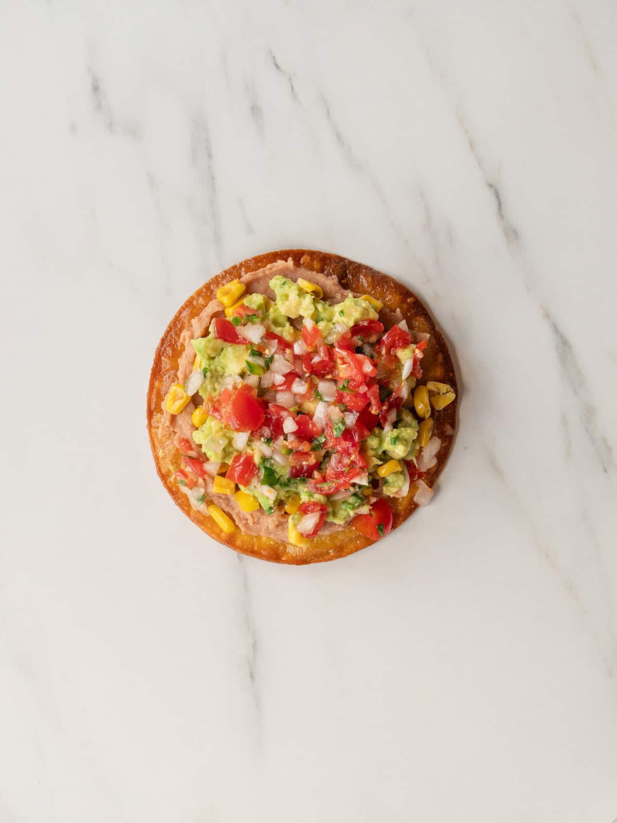 Colorful tostada with fresh toppings