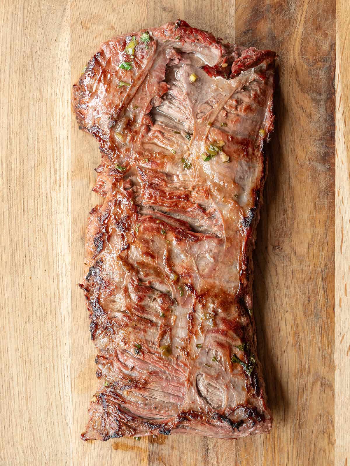 Grilled beef with marinade on wood
