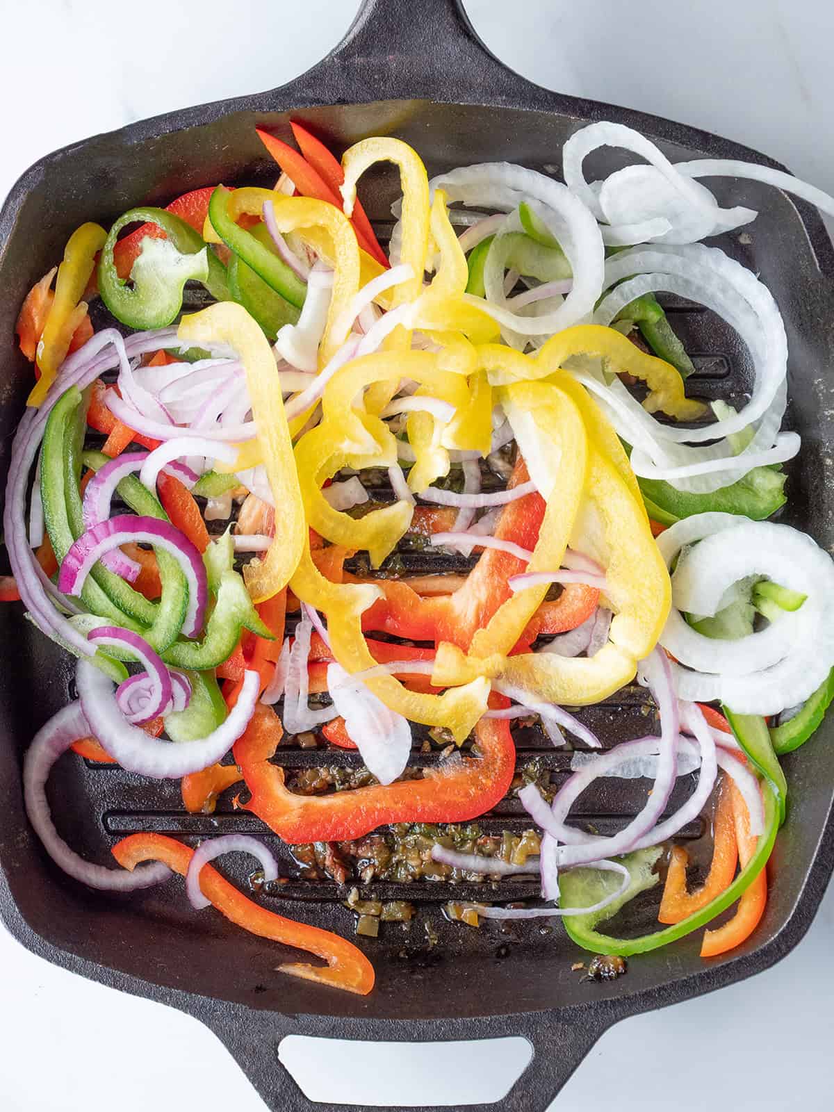 Colorful sliced peppers and onions