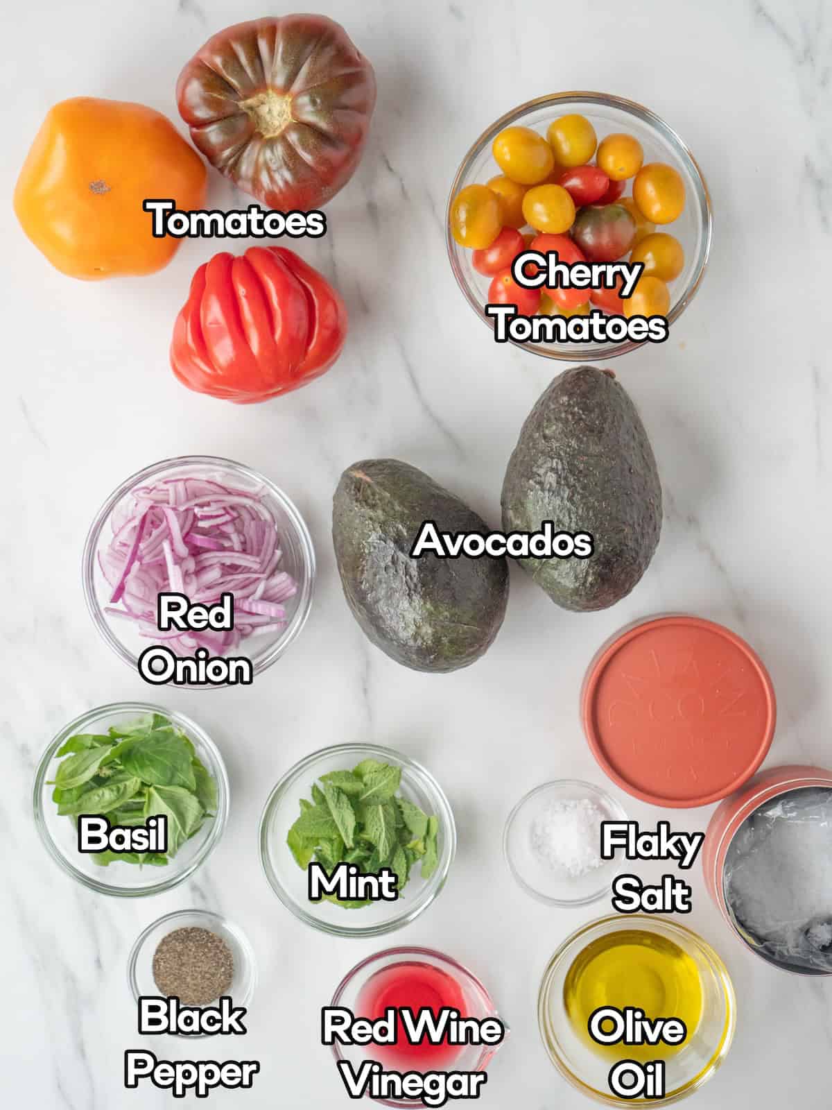 Mise en place of all ingredients to make avocado and heirloom tomato salad.