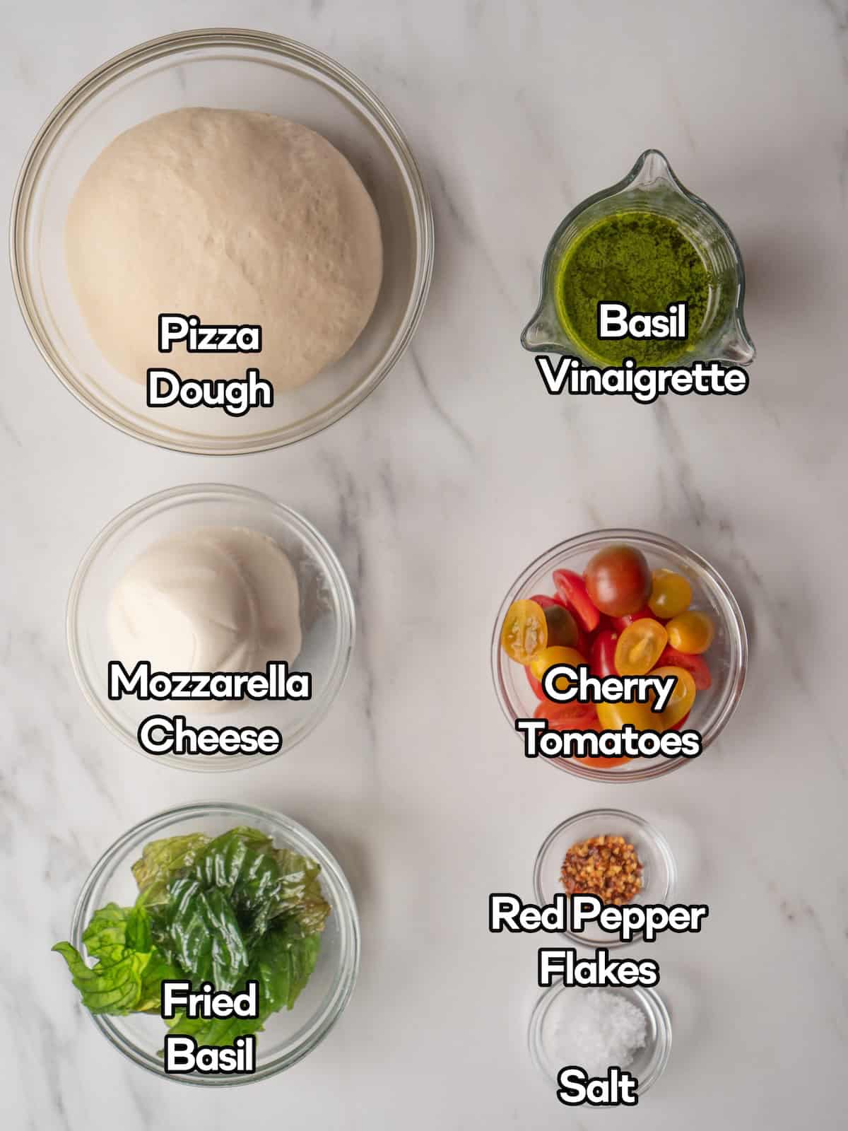 Mise en place of all ingredients to make pesto caprese pizza.