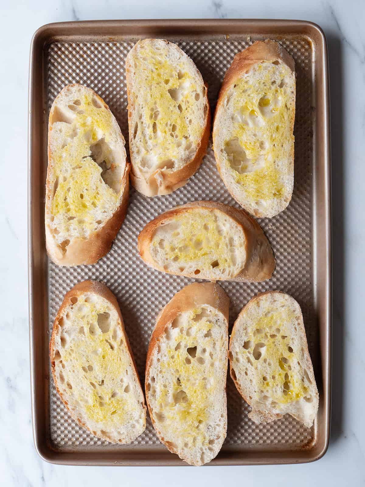 Sliced bread on a baking tray