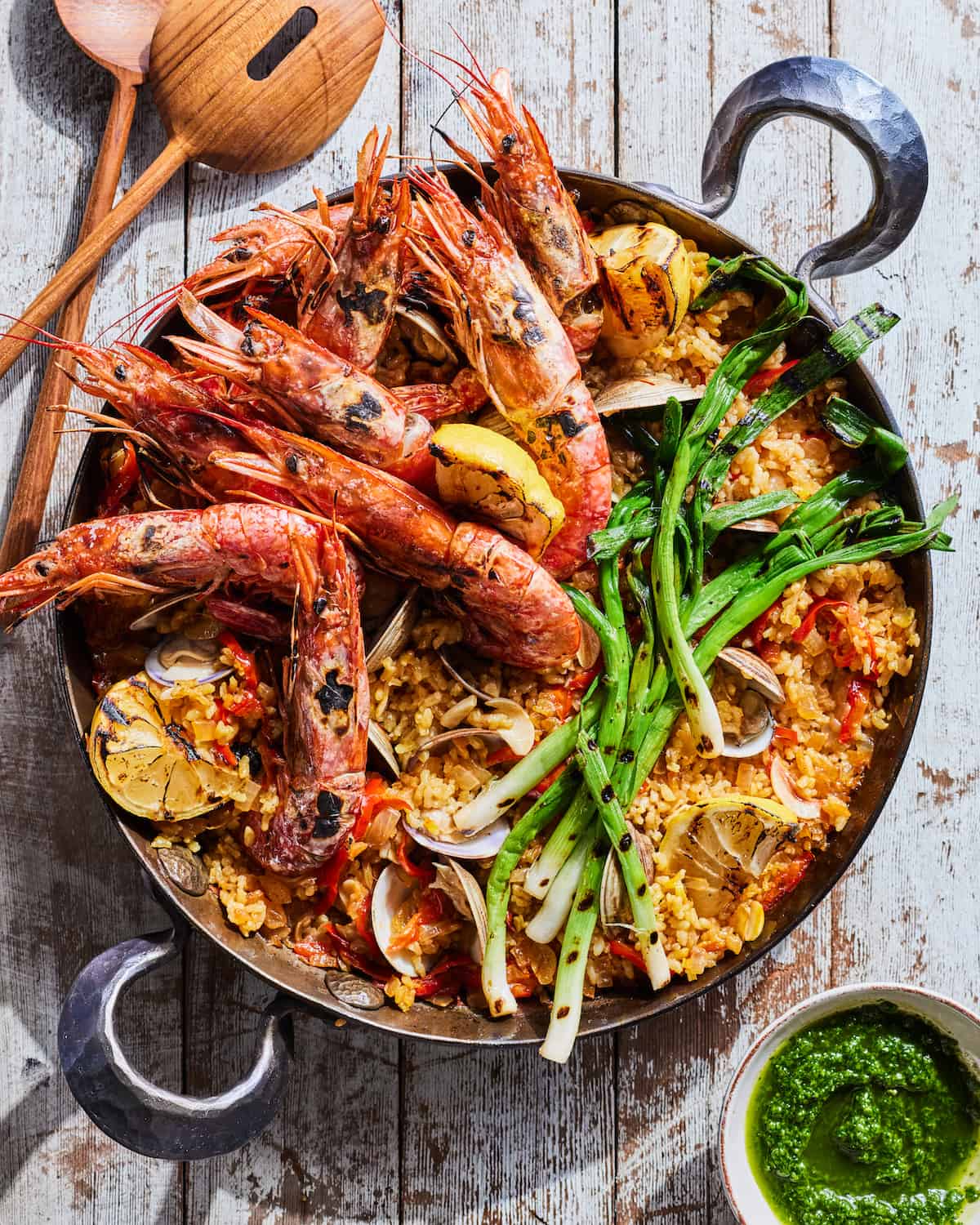 Seafood Paella in a large serving dish with a cilantro sauce