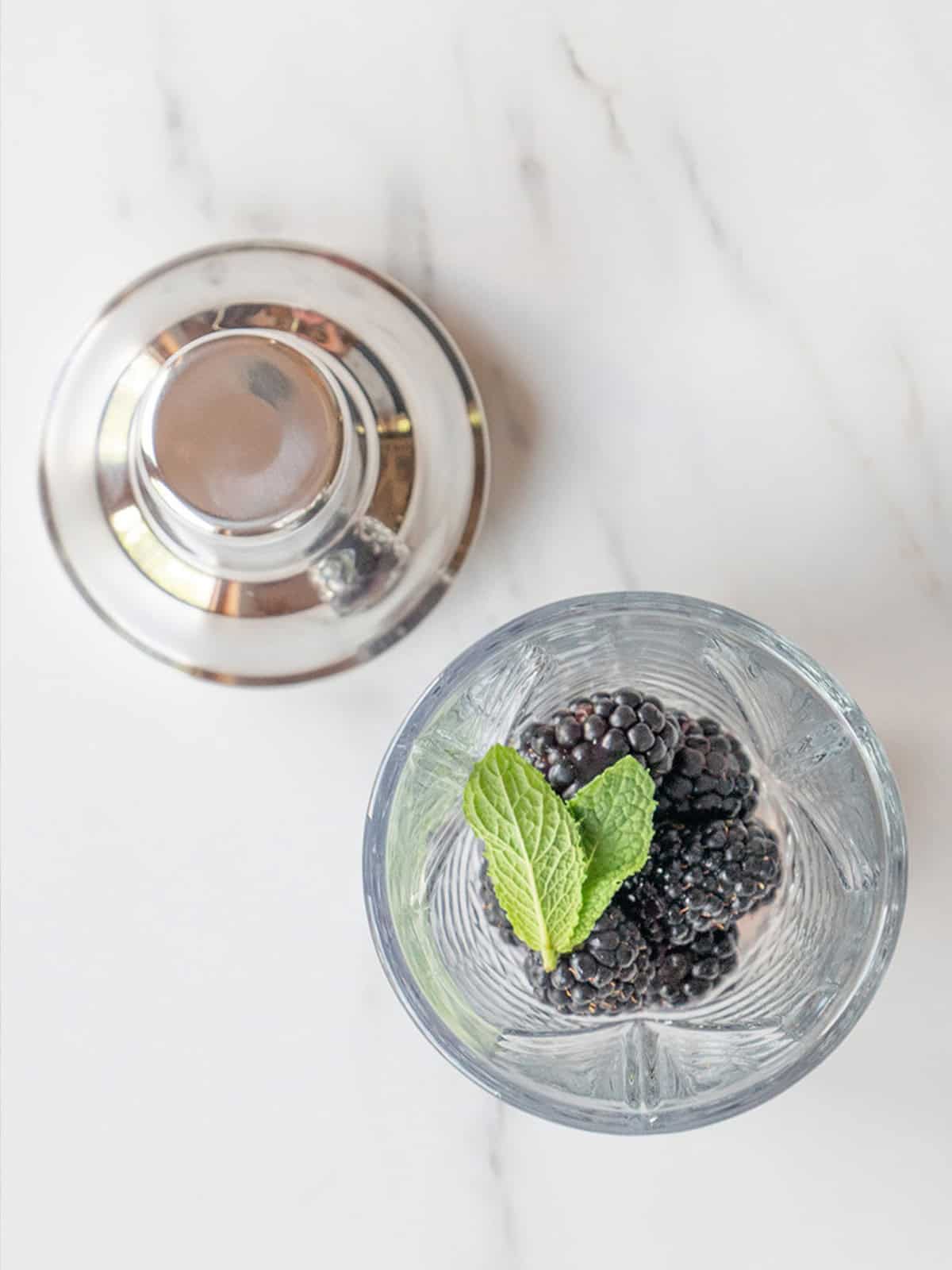 Cocktail with blackberries and mint