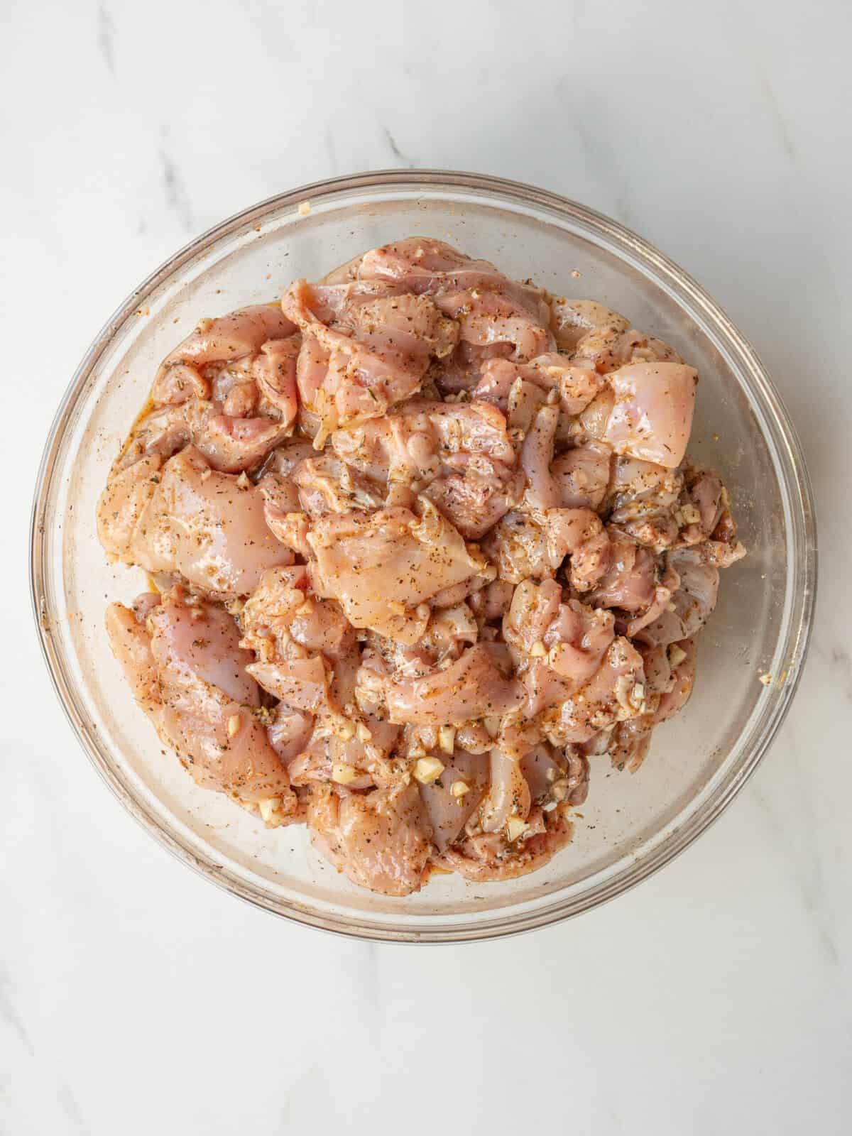 Marinated chicken pieces in a bowl