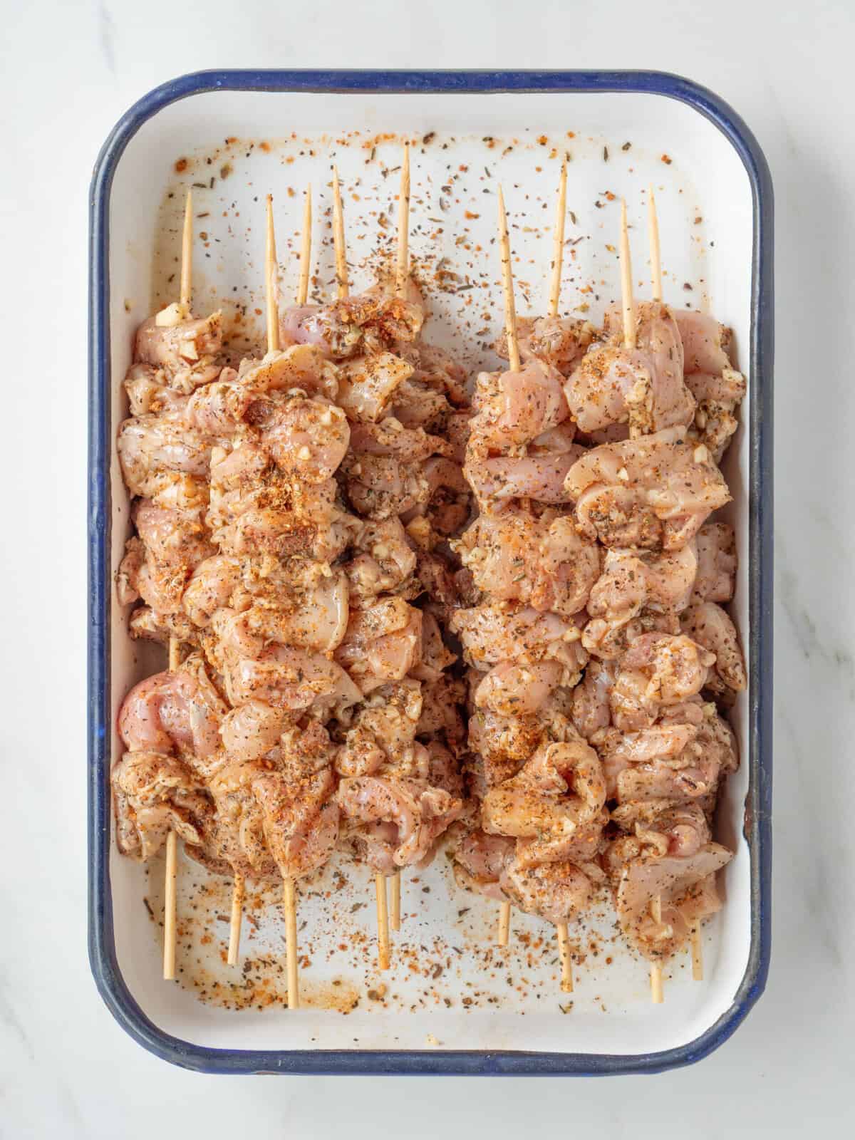Raw chicken skewers with seasoning
