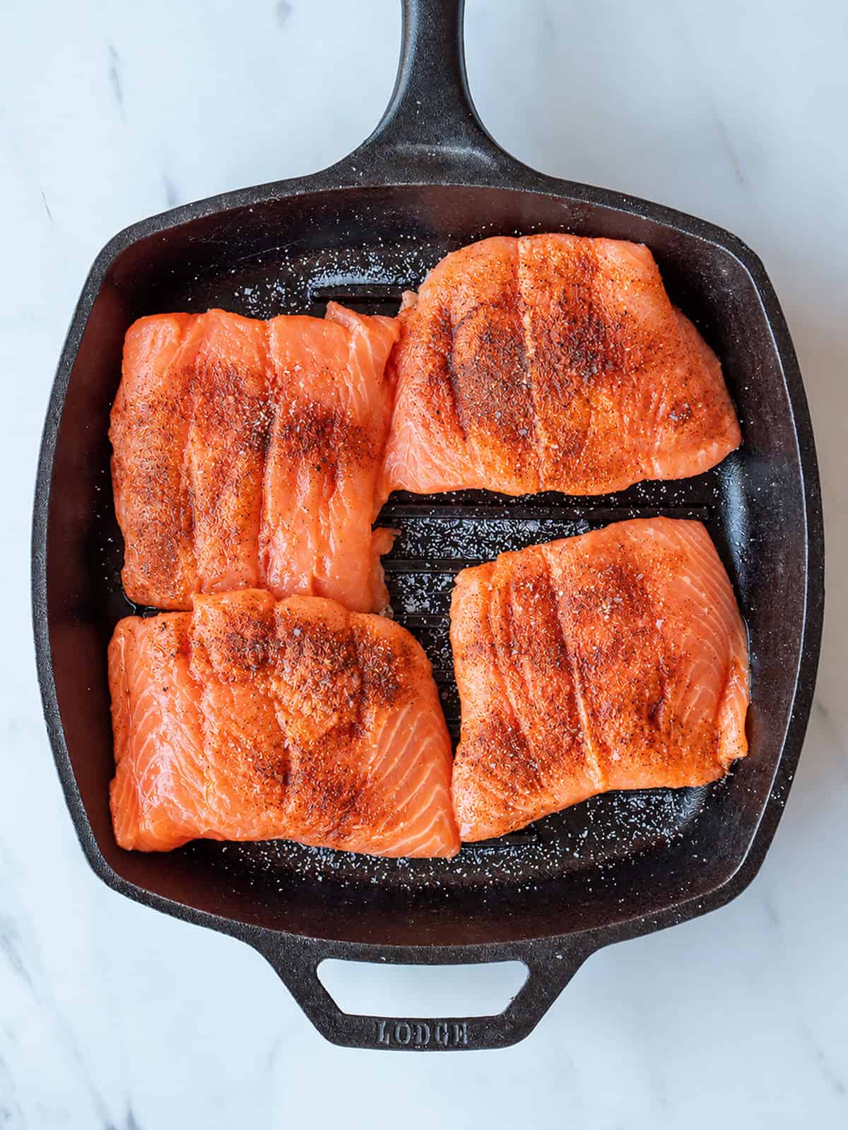 Chipotle salmon cooking in a grill pan