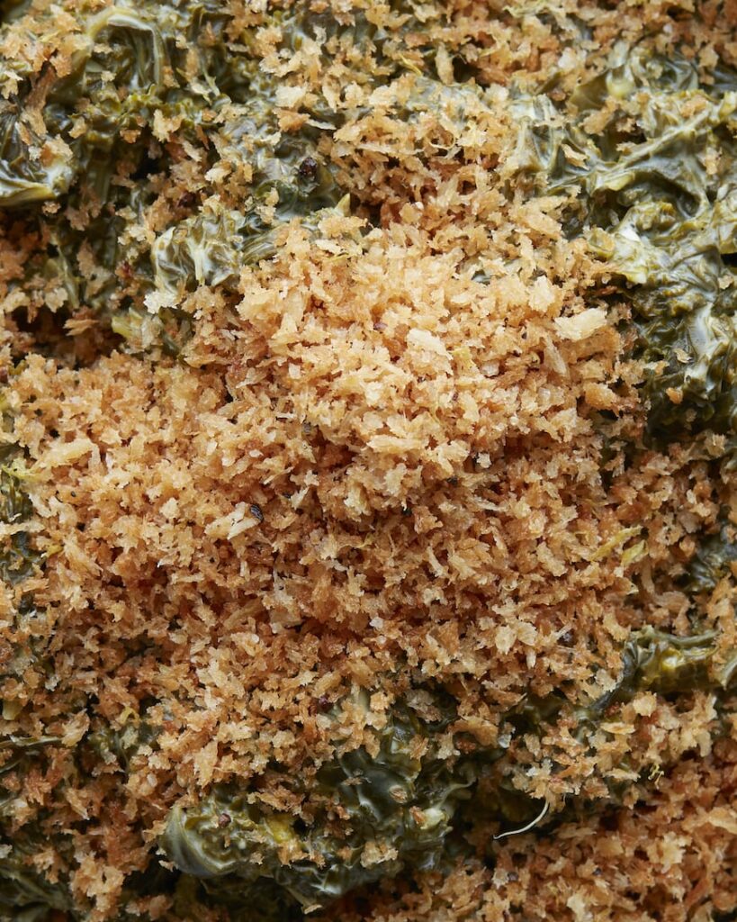 A close-up shot with cheese creamed kale with panko bread crumbs on top.