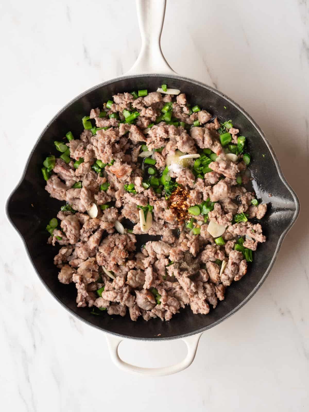 Cooked sausage with green onions