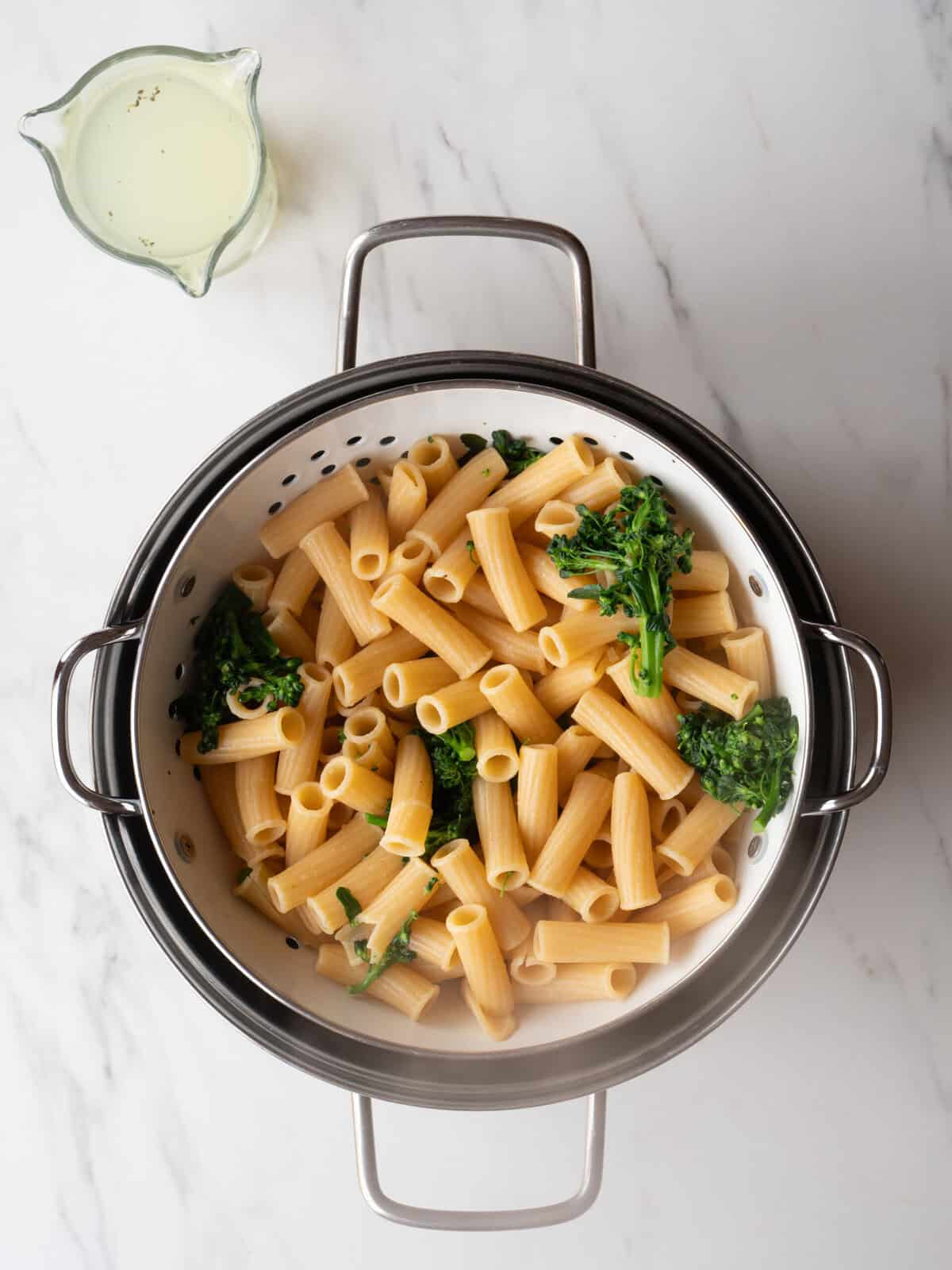 Cooked rigatoni with broccoli in colander