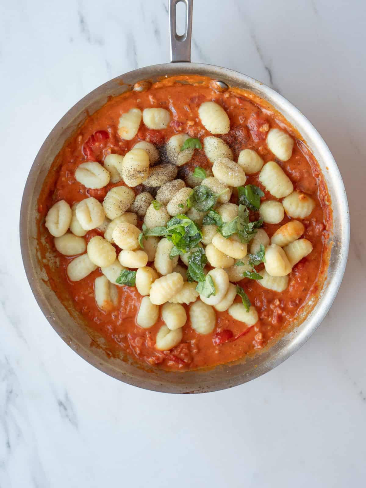Gnocchi in creamy tomato sauce with herbs