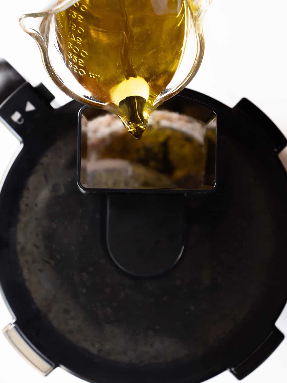 Pouring oil into a food processor