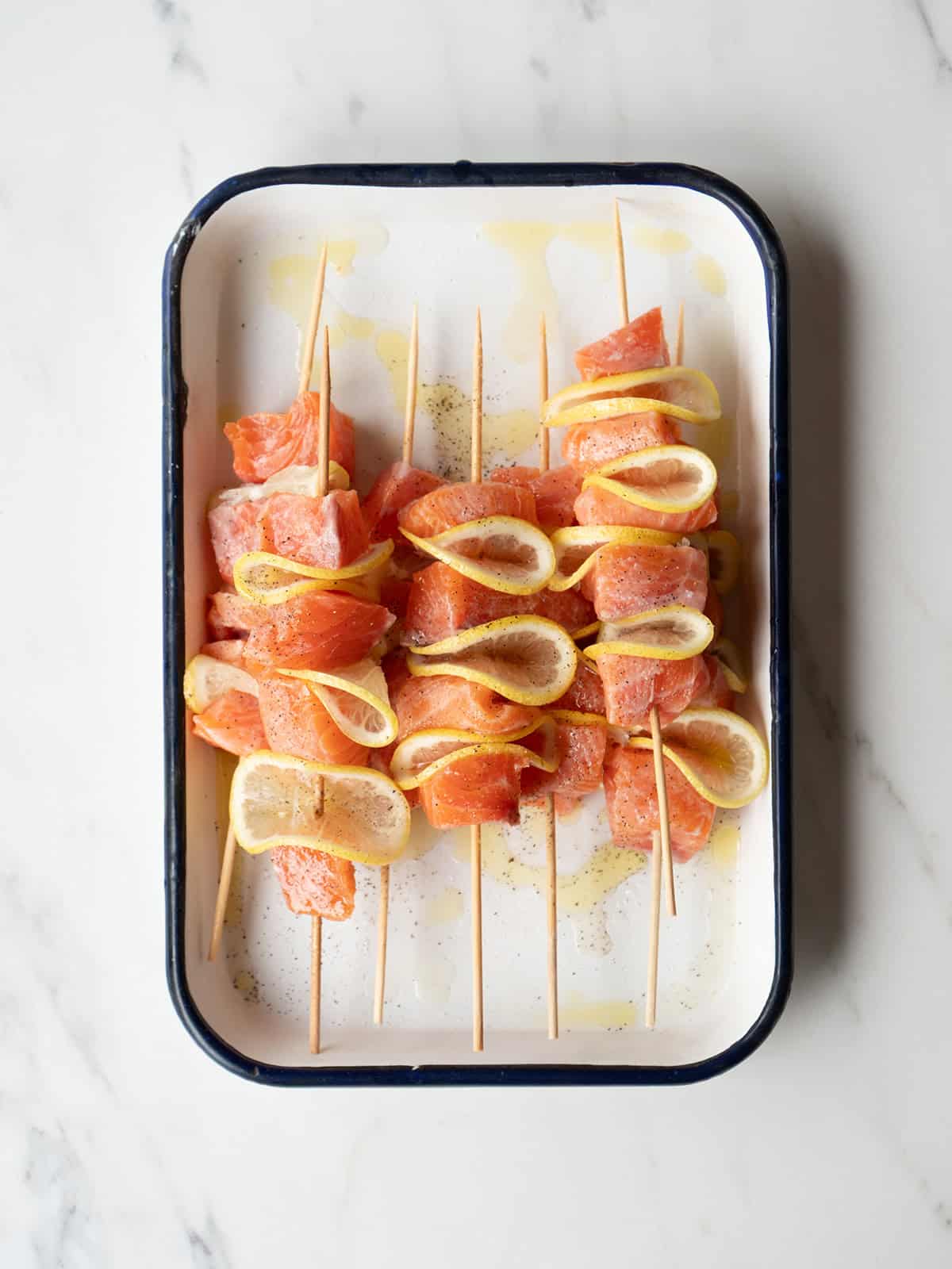 Salmon and lemon skewers on tray