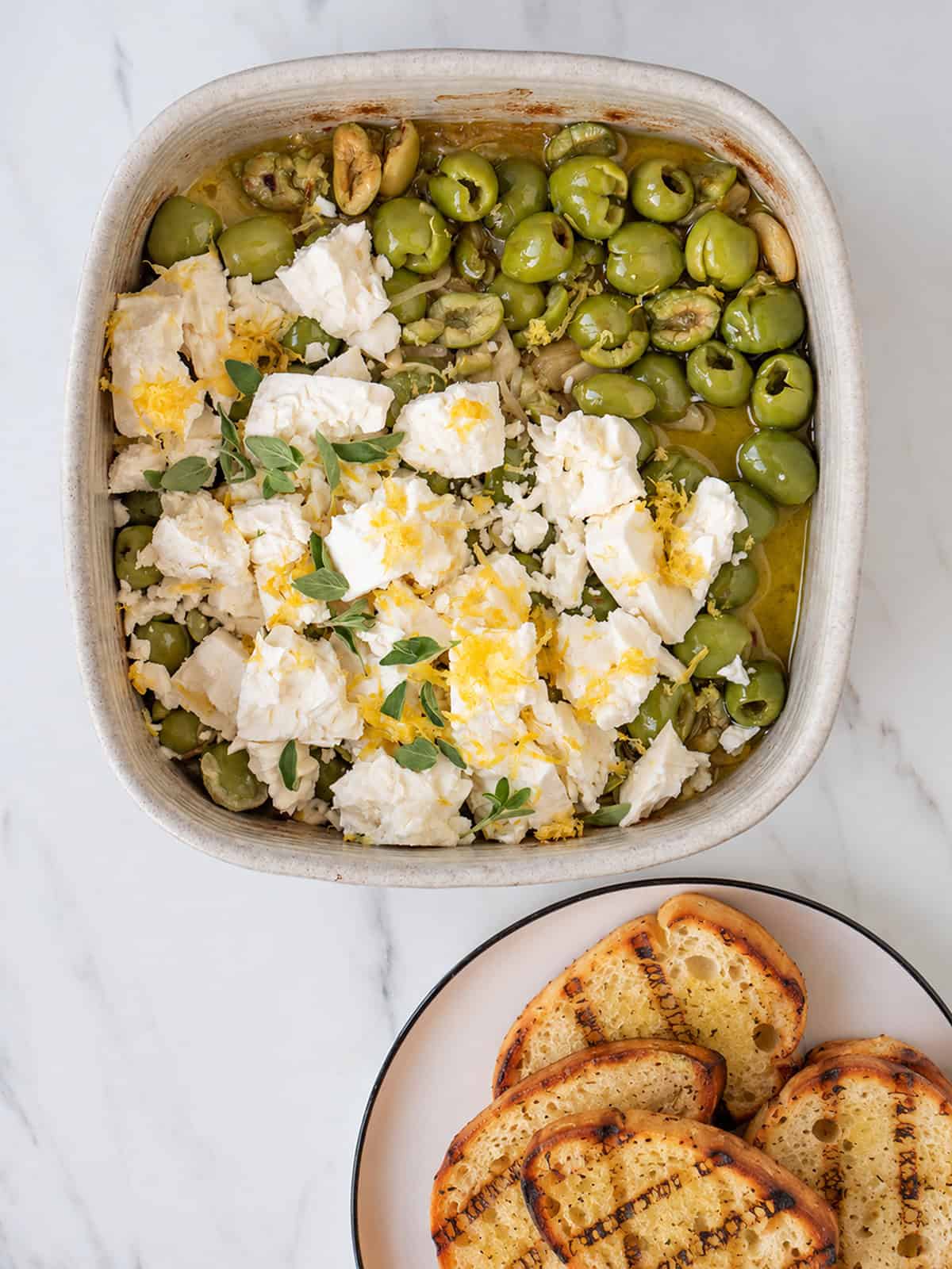 Spicy roasted Castelvetrano olives with feta and grilled bread