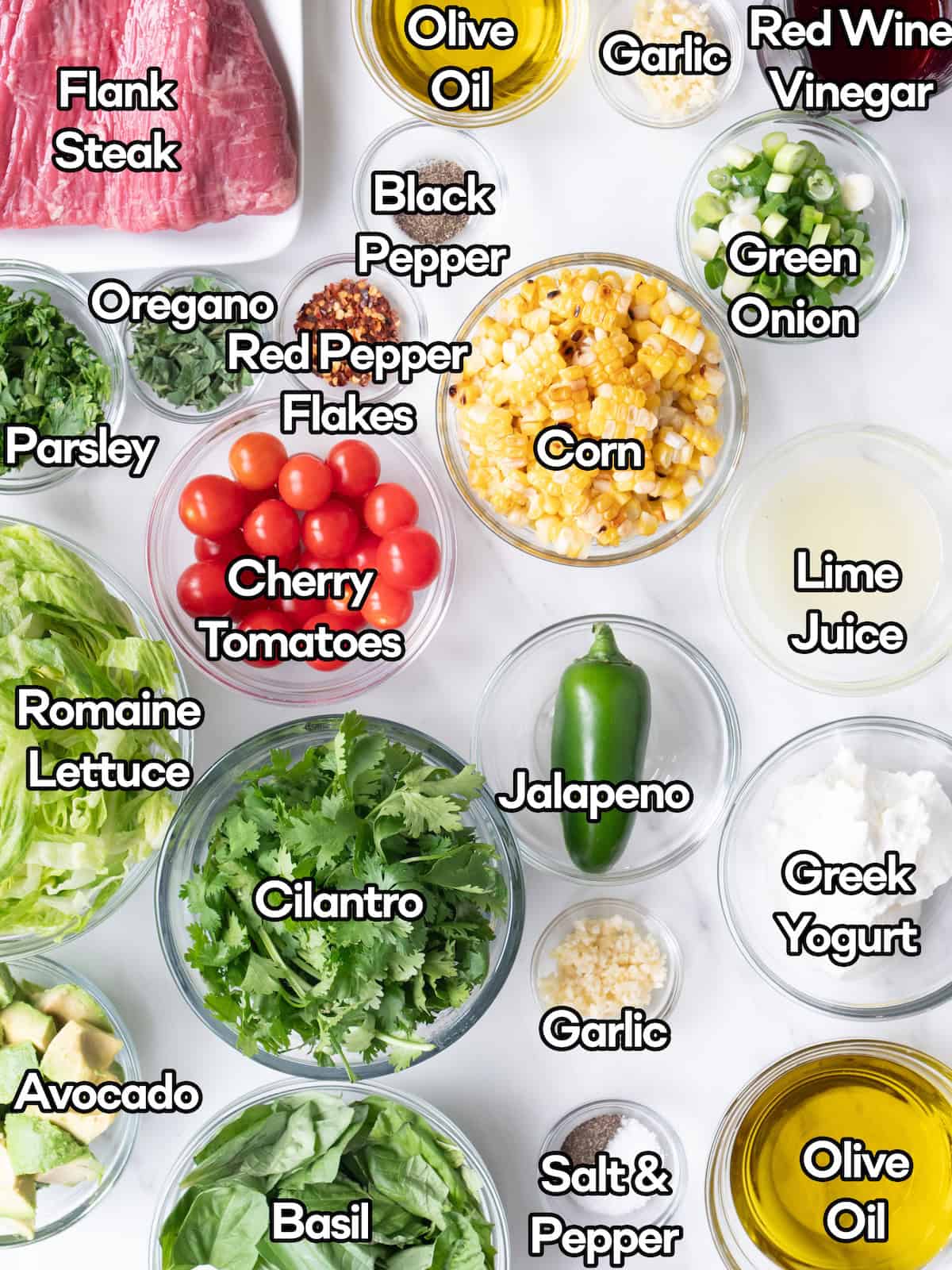 Mise en place of all ingredients to make a grilled steak salad with a yogurt green goddess dressing.