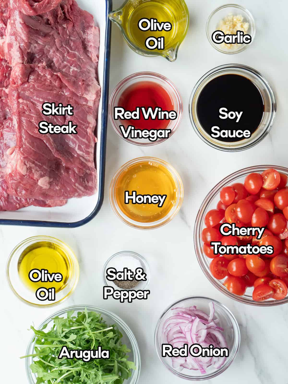 MIse en place of all ingredients to make grilled skirt steak and tomato salad.