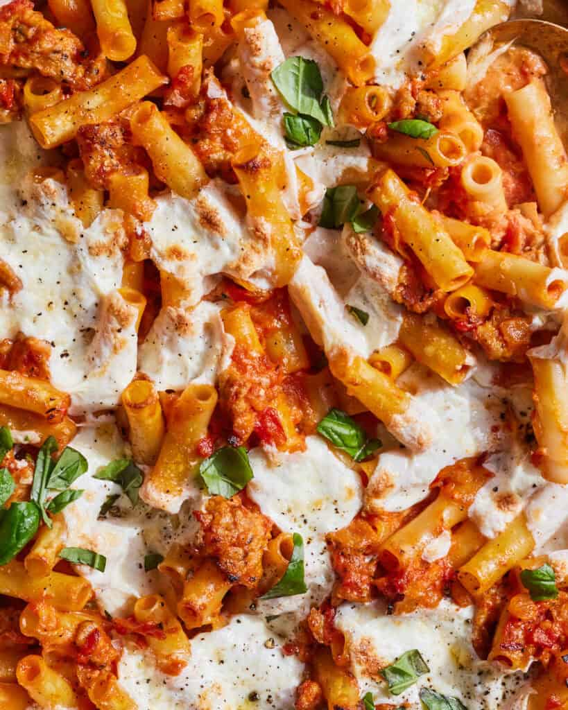 An overhead close up shot of cheesy chicken sausage pasta bake.