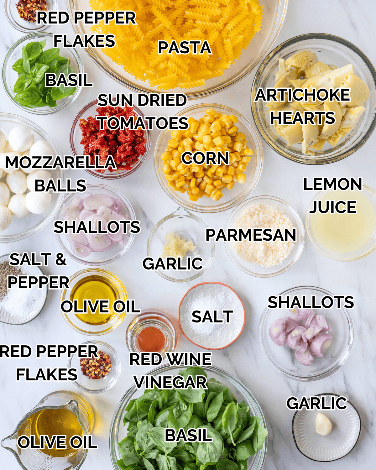 An overhead shot of all the ingredients sitting on a table in individual glass prep bowls.  