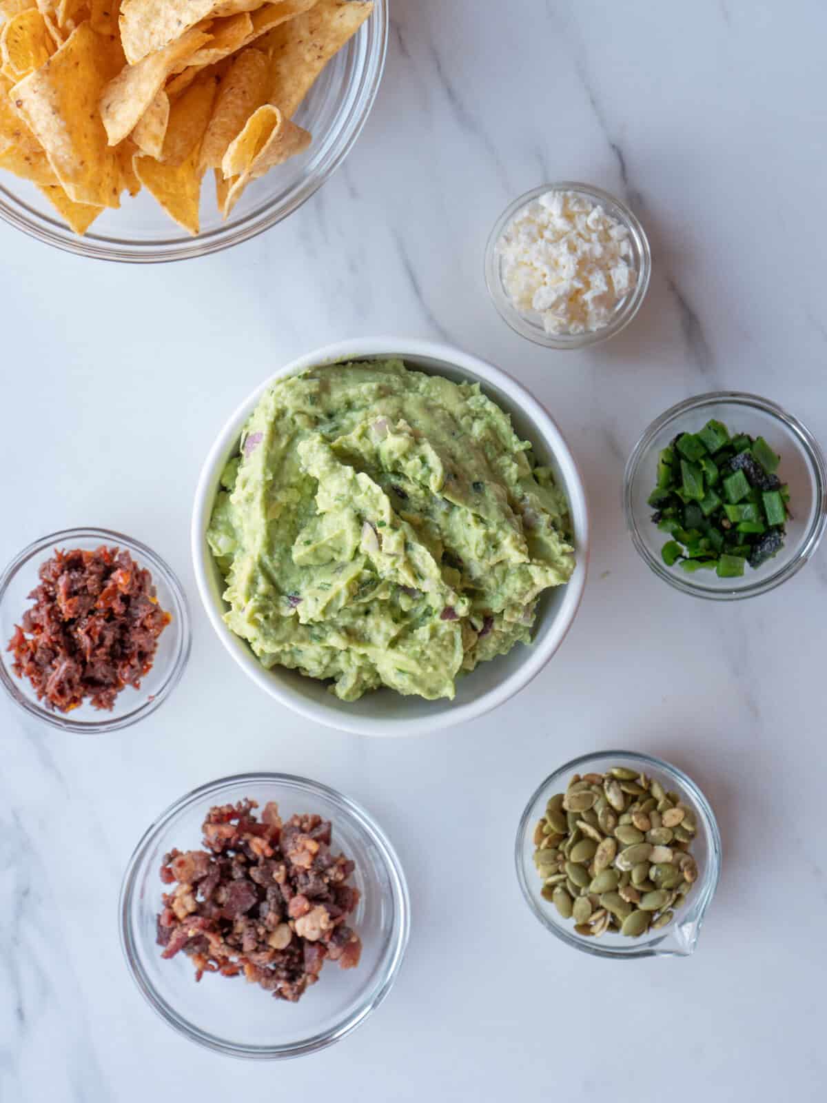 Guacamole with toppings and tortilla chips