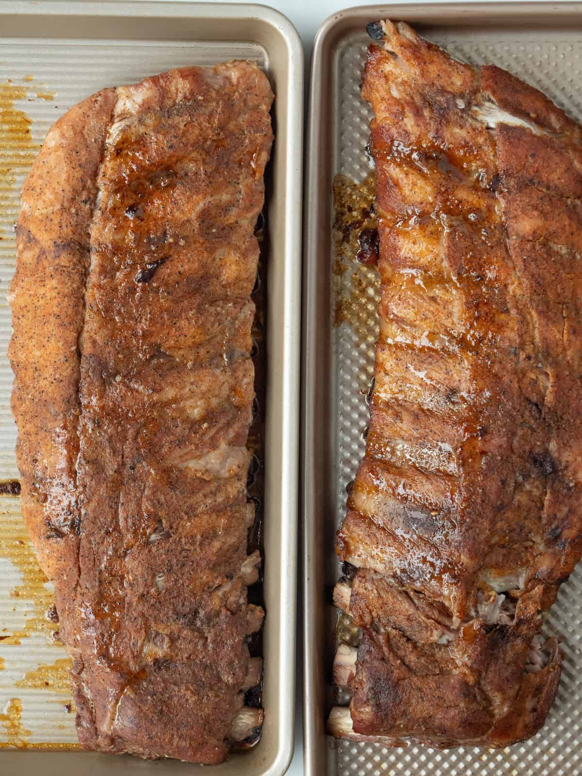 A baking sheet with a baked rack of baby back ribs