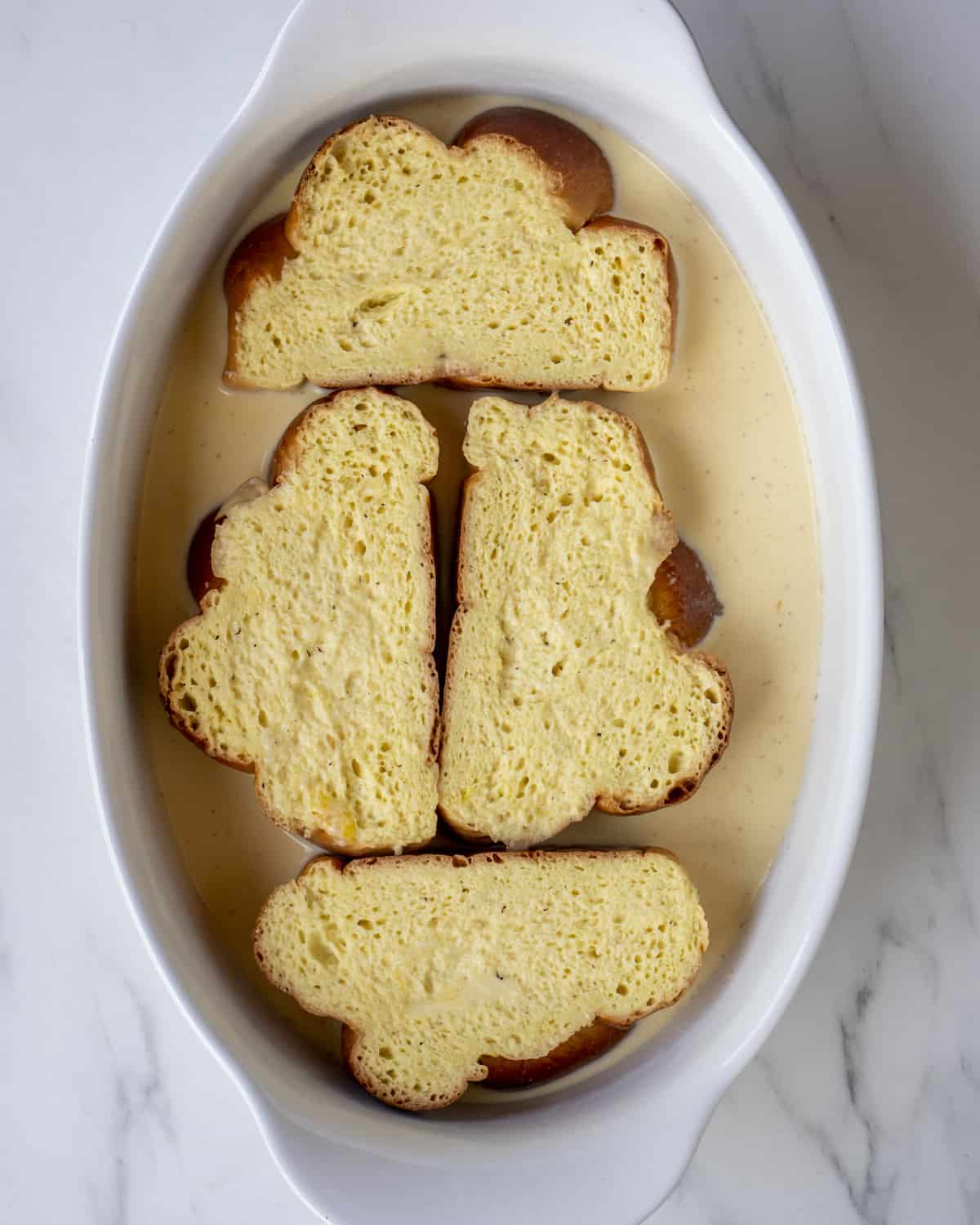 Deep baking dish with bread soaked into french toast batter.