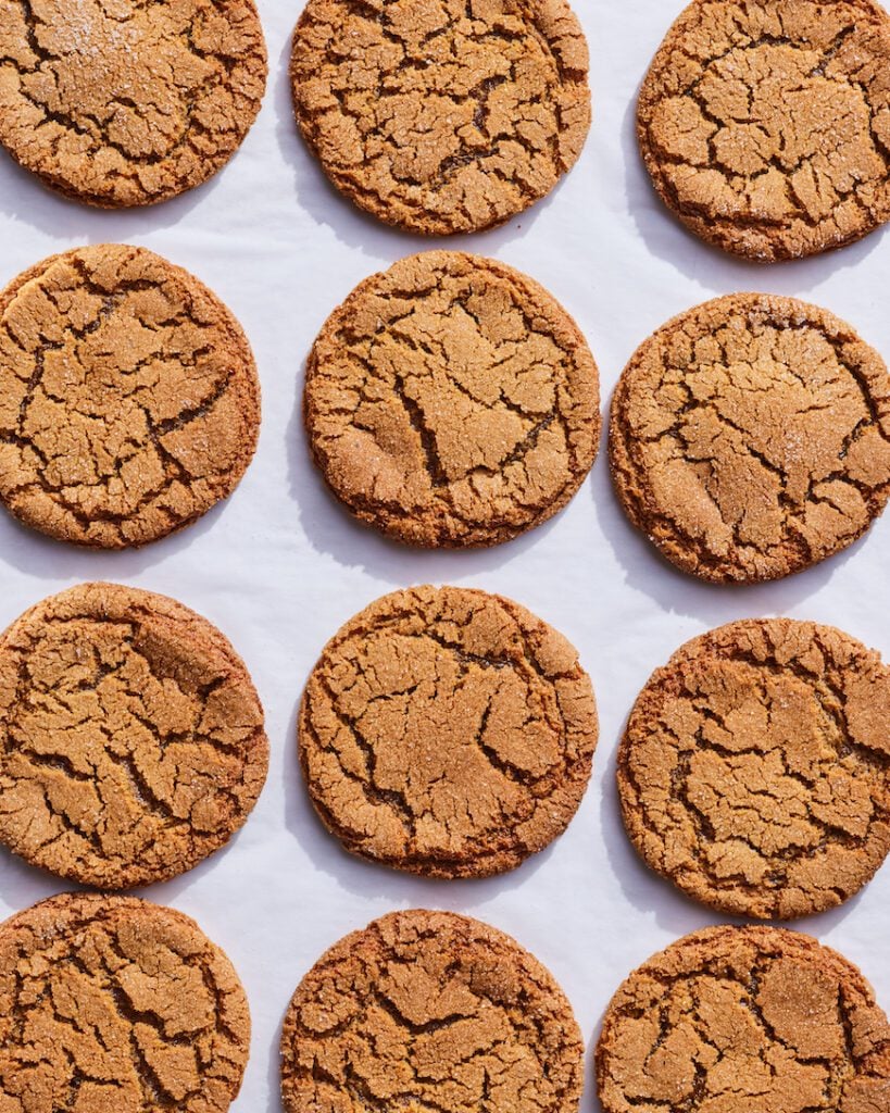 A dozen of Molasses Cookies on a piece of parchment paper from www.whatsgabycooking.com (@whatsgabycookin)