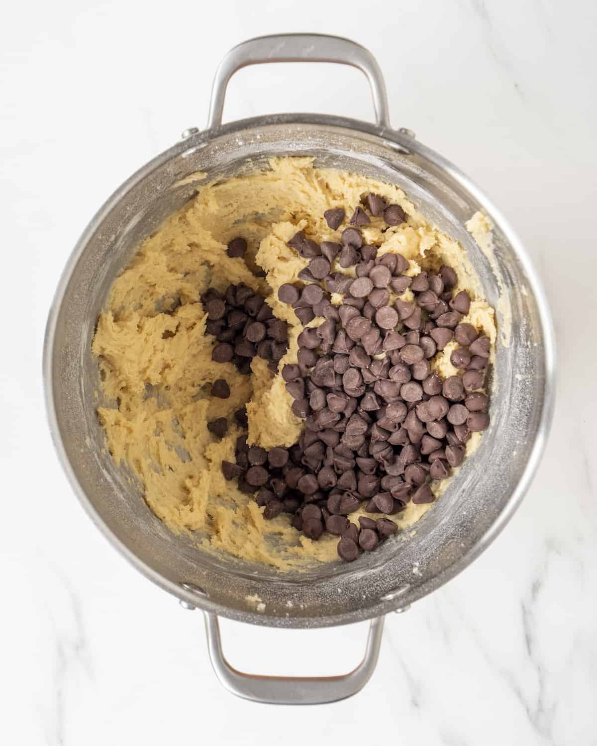 A bowl filled with cookie dough and chocolate chips.  