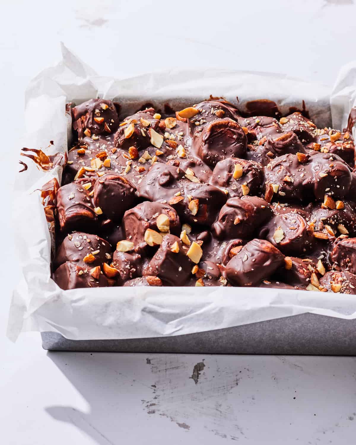 rocky road brownies in a 9x9 metal baking pan lined with parchment paper