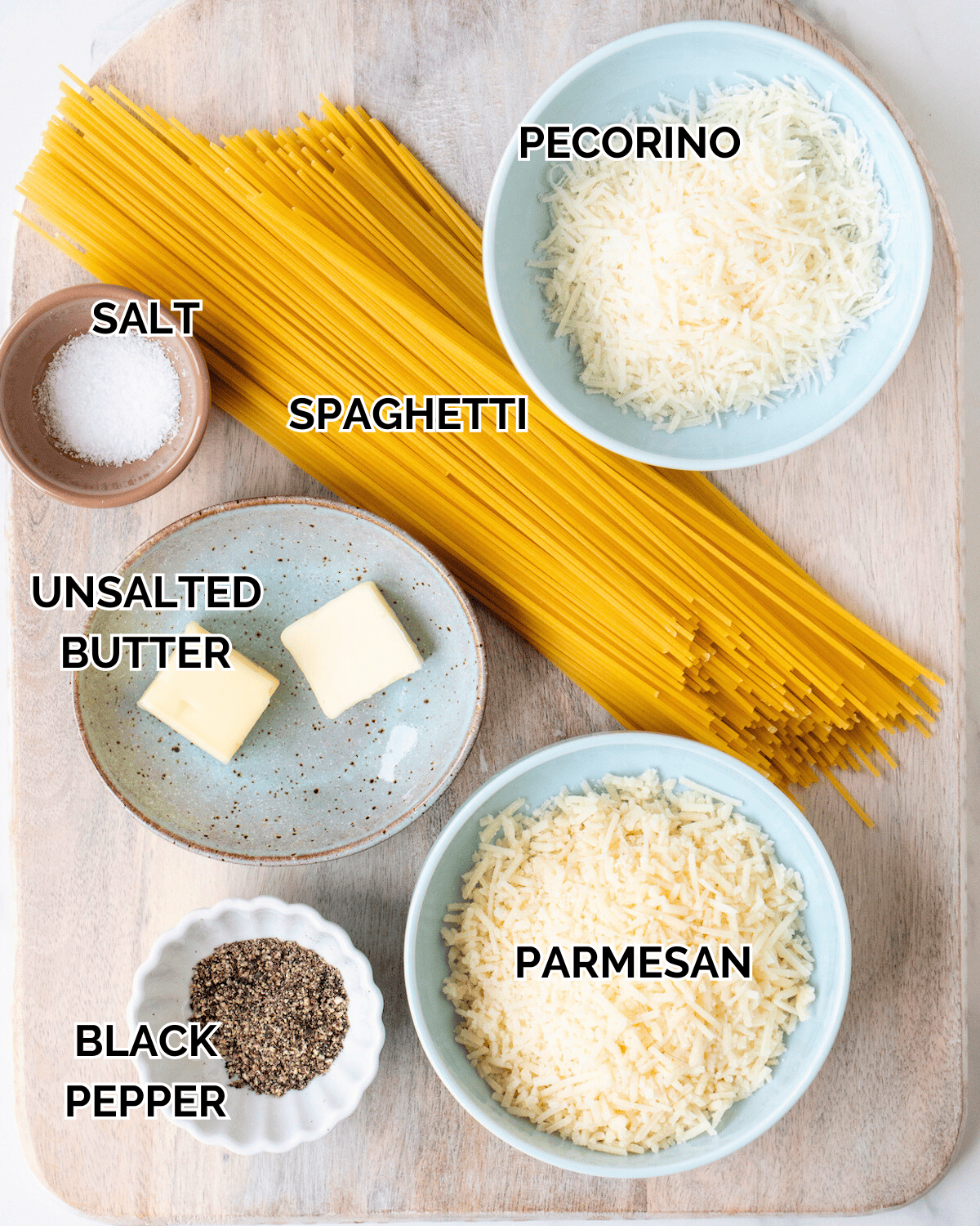 Dry Spaghetti, a bowl of salt, a bowl of pecorino, a bowl of unsalted butter, a bowl of black pepper, and a bowl of grated parmesan.  