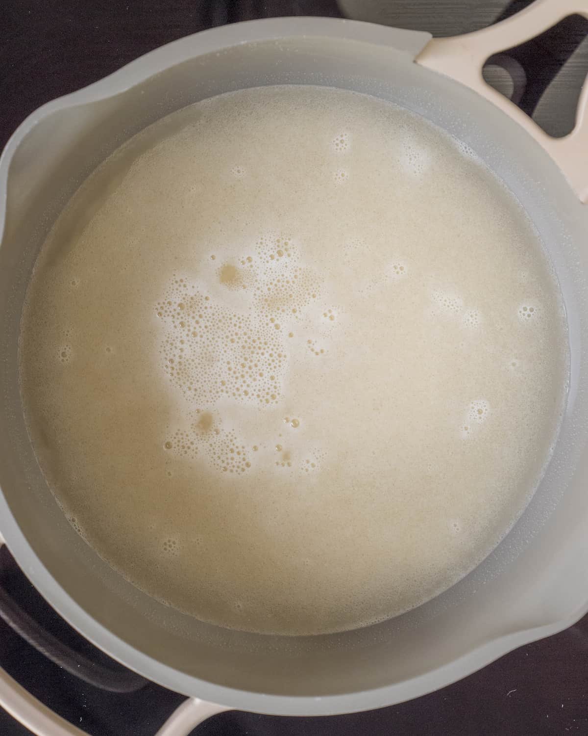 White rice that has just been covered with water in a saucepan.