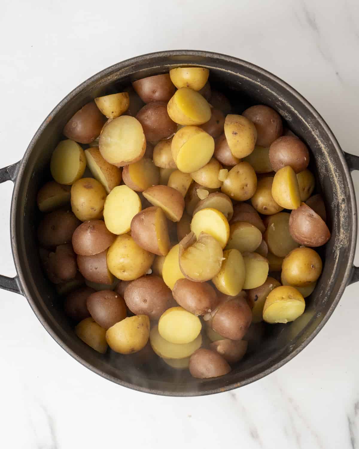 Boiled baby potatoes in a pot.