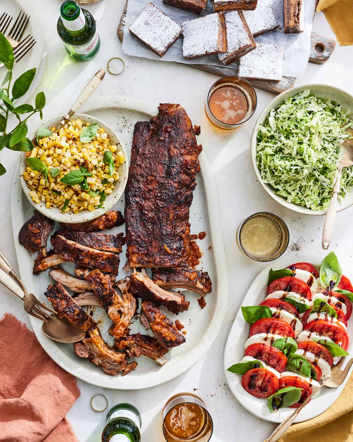 A dinner party spread with BBQ Baby Back Ribs, BBQ Corn Salad, an easy Slaw Salad and Caprese! 