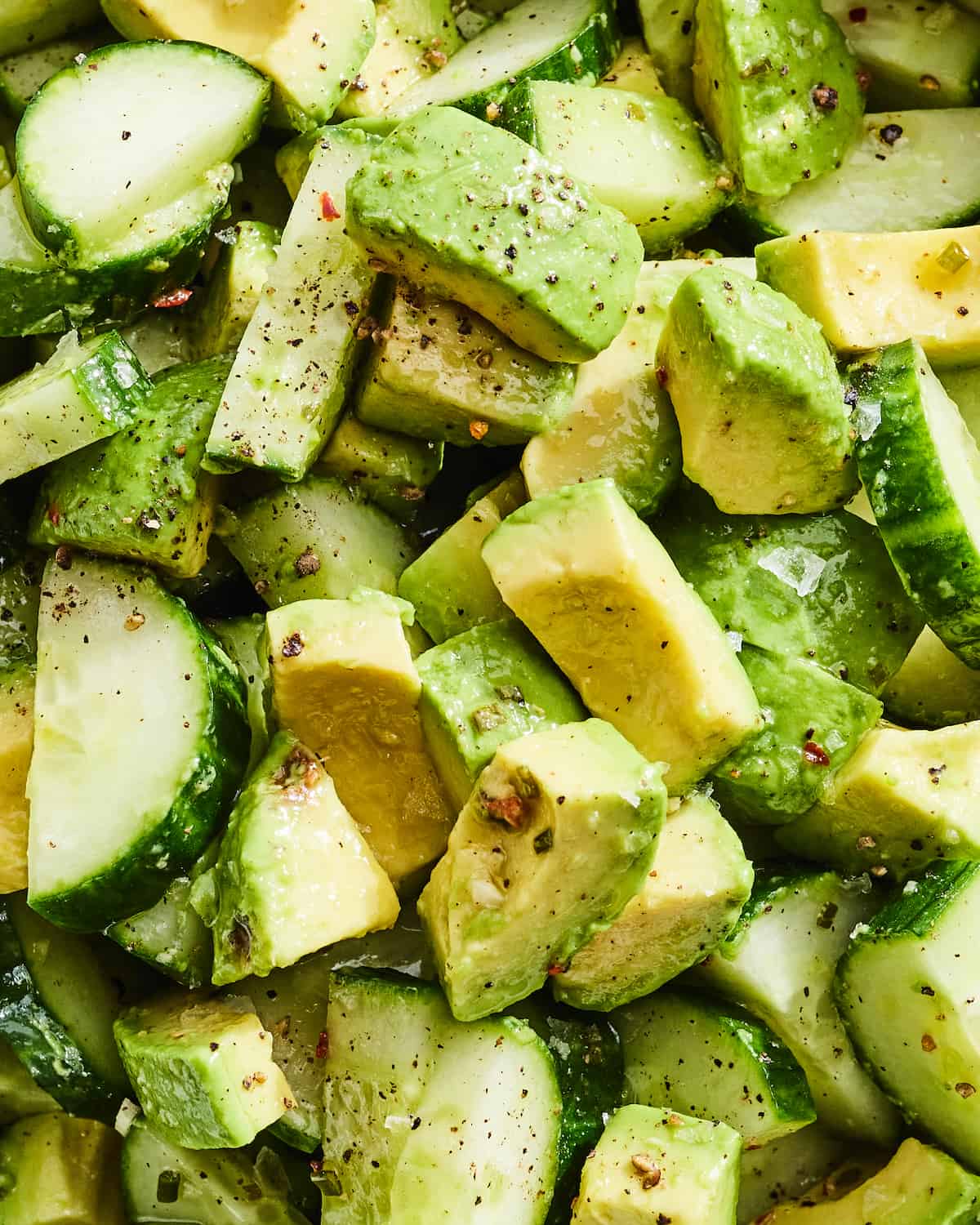 Diced cucumbers and diced avocado seasoned with flaky sea salt, pepper, and olive oil.  
