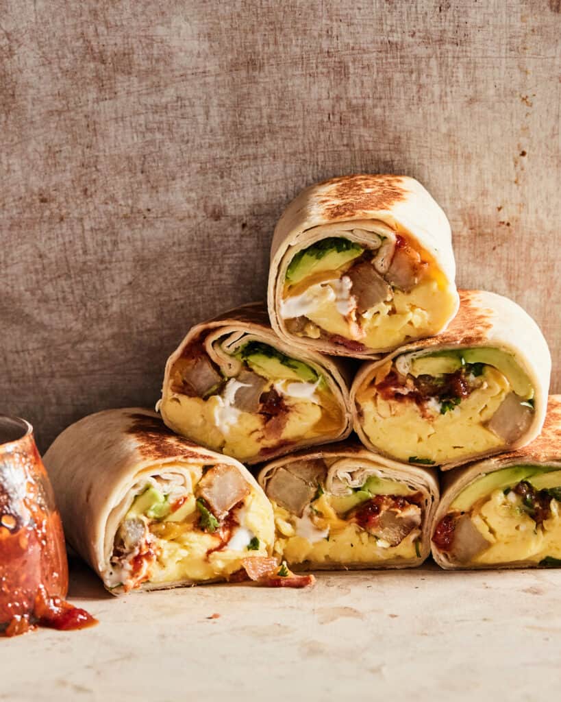 Stacked breakfast burritos with fillings