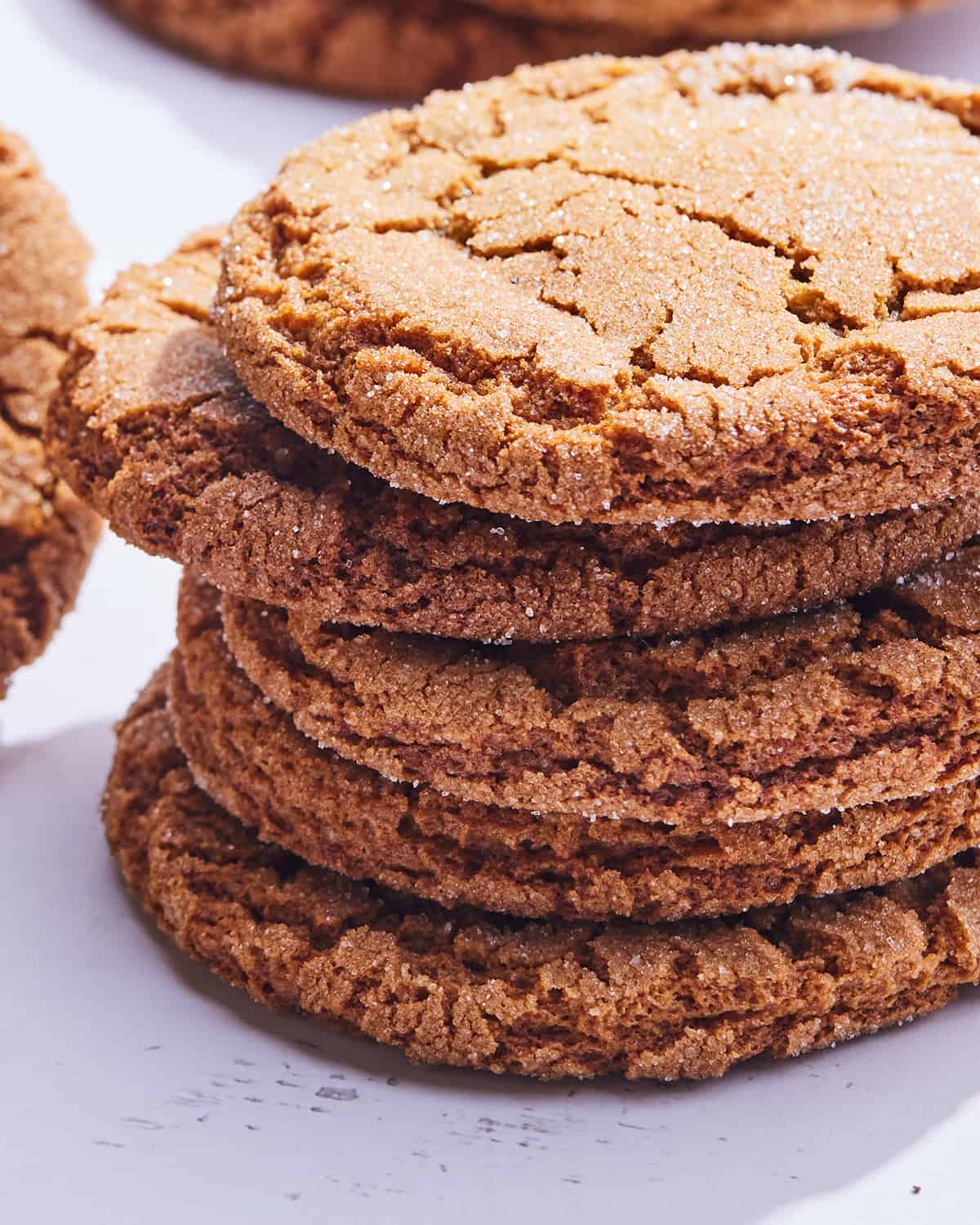 A stack of 5 molasses cookies with sugar.  