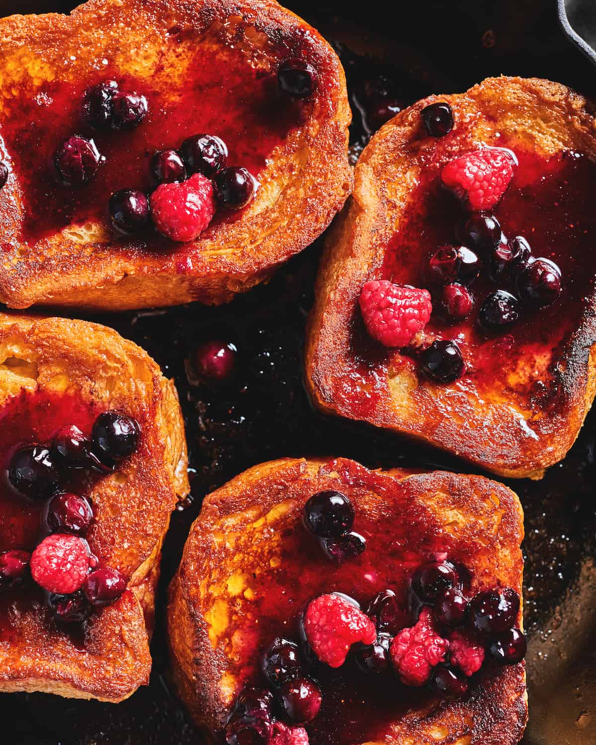 Close up shot of Caramelized French Toast with Berry Compote on top.