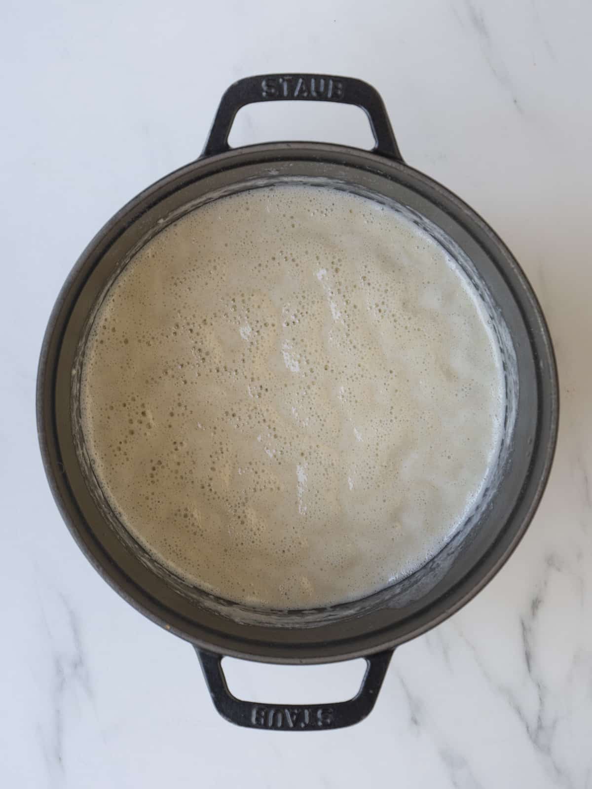 A round pot with a butter and flour roux thickened into a gravy by slowly streaming in braising liquid.