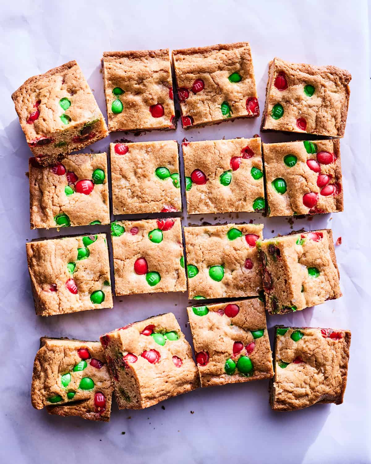 An overhead shot of 16 square Christmas MM Cookie Bars