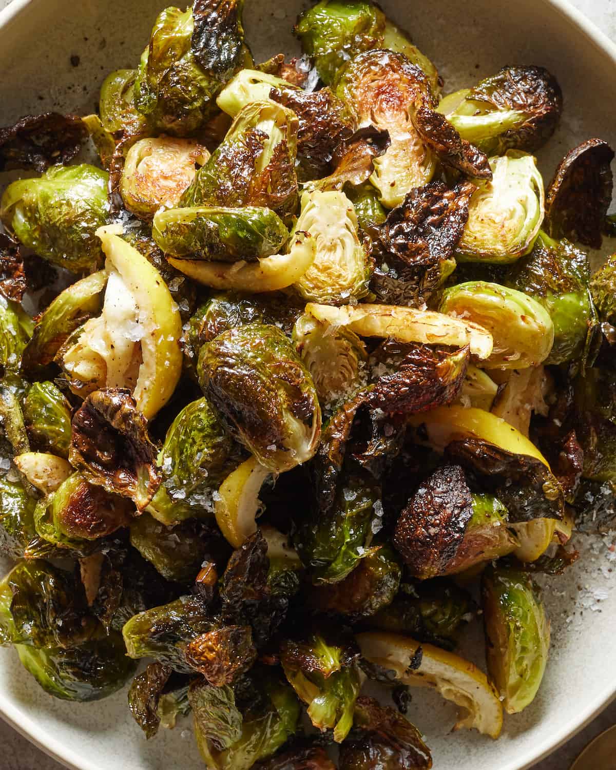 A close-up shot of crispy lemon brussels sprouts in a small dish.