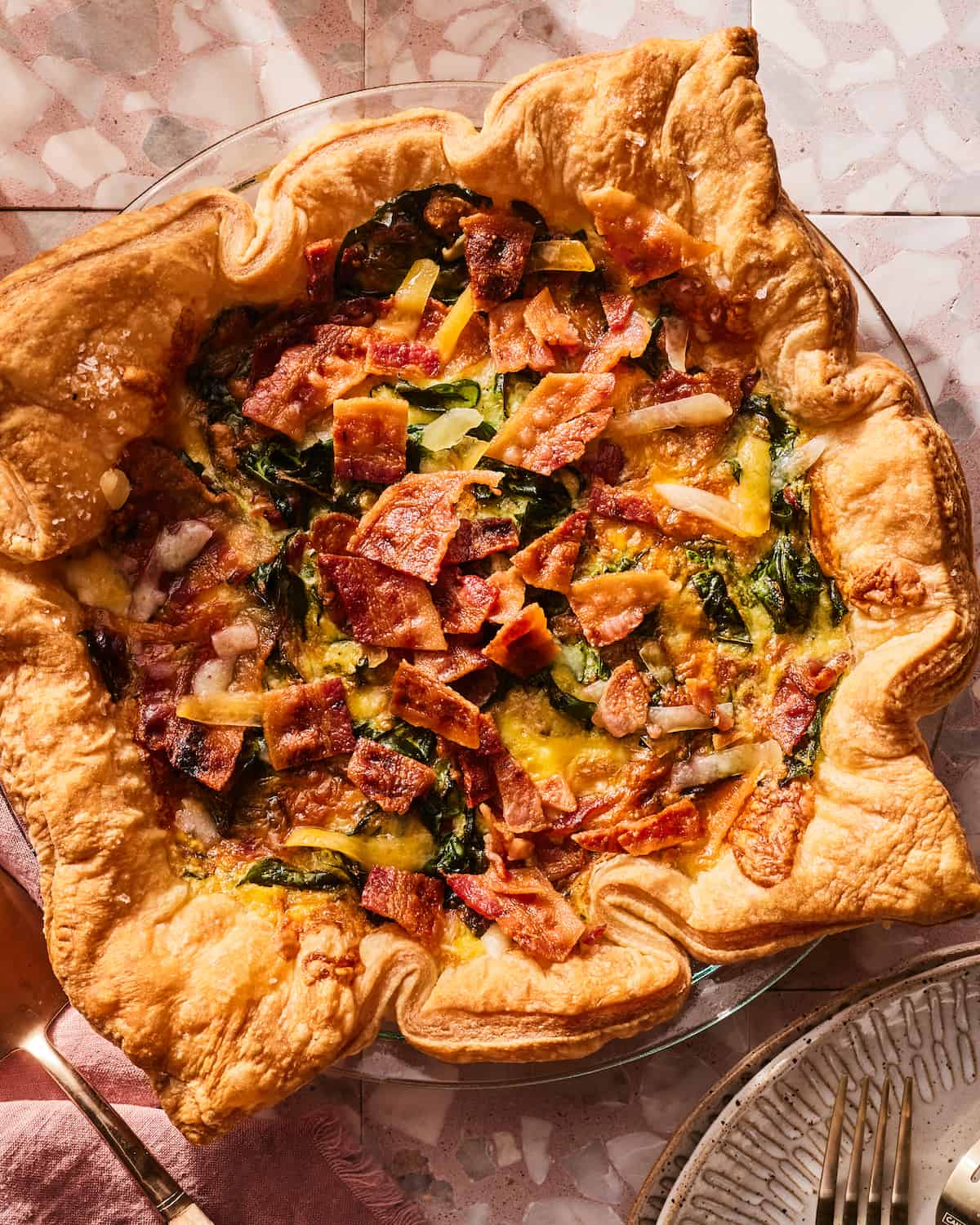 Close up shot of a Cheddar Bacon Quiche with Spinach