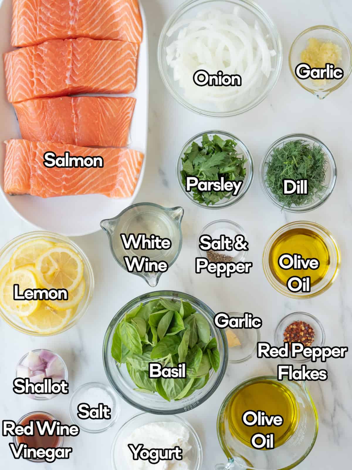 Mise-en-place with all the ingredients required to make steamed salmon and an herby green yogurt sauce.
